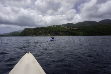 Kayaking in the Caribbean during a storm. High quality photo. Cloudy, sports