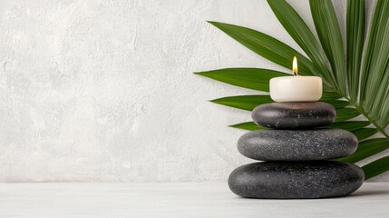 Tranquil Stone Stack with Candle and Green Leaf on Minimalist Background
