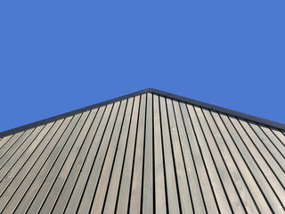 striped plank wall transitioning into gable, low angle view