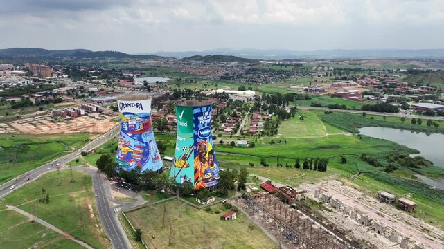 SOWETO, SOUTH AFRICA, aerial video footage flying left along painted Orlando Towers, chimneys at Soweto, a famous landmark of the township of Johannesburg, located next to Orlando Dam. 