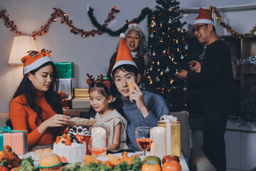 Happy family with gifts celebrating Christmas together