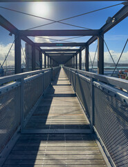 Auckland, New Zealand. The Gantry at Silo Park, Wynyard Quarter on the waterfront, a 100 metre long steel structure for the public to climb and take in the views. Auckland Harbour Bridge in distance.