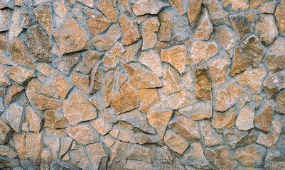 Texture of a stone wall. Finishing the facade of the building with natural stone. Part of a stone wall, for a background or texture. close up