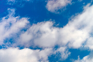 A few light cumulus clouds in a clear blue sky. summer bright image of the sky.
