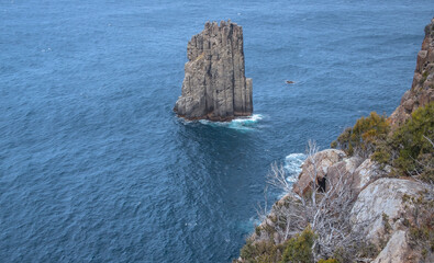 Breathtaking view of Cape Hauy Tasmania featuring rugged cliffs lush greenery and the vast ocean....