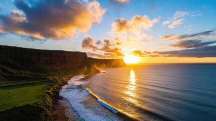 Dramatic coastline at sunset with waves and cliffs in background