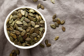 Healthy Raw Organic Pumpkin Pepita Seeds in a Bowl, top view.