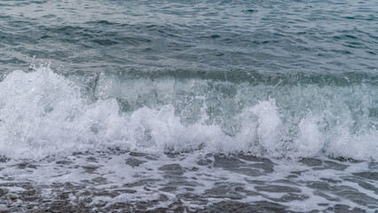 Water sea beach. Wave ocean blue. Stone texture reflection sun. Surface coast pebbles. 