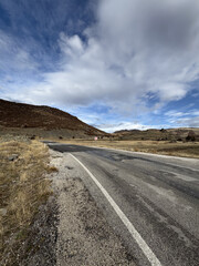 road in autumn in the mountains dry grass asphalt. High quality photo