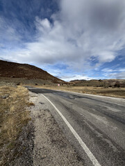road in autumn in the mountains dry grass asphalt. High quality photo