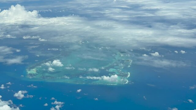 aerial landscape video footage of Farquhar Atoll in the territory of Seychelles, located in Indian Ocean - partly covered with clouds - 4K aerial video 