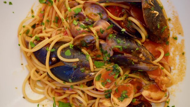 Top shot of Spaghetti allo Scoglio, seafood pasta elegantly arranged on a plate in Sicily, Italy