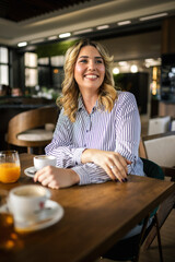 Portrait of beautiful woman drinking coffee in a restaurant.