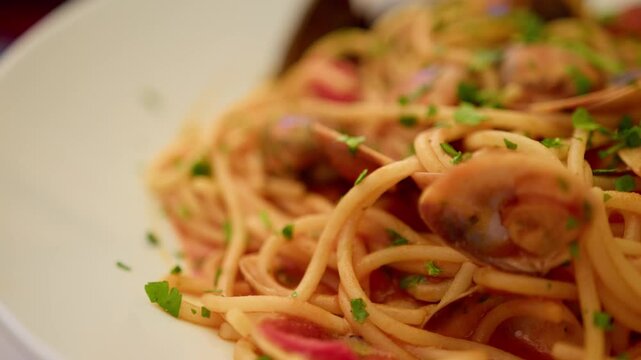 Super close-up of Spaghetti allo Scoglio with seafood on a plate in Sicily Italy