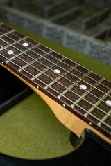 Obraz premium detail of the neck and strings of an electric guitar
