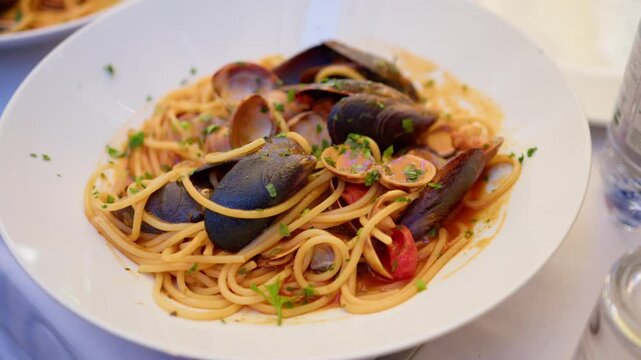 Close-up of a plate of Spaghetti allo Scoglio, seafood pasta with vibrant flavors in Sicily, Italy