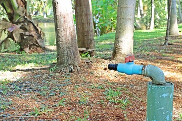 Water PVC faucet with metal pipe on field in a park