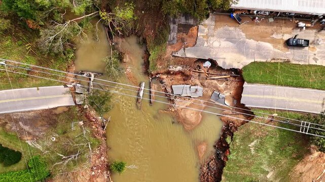 Bridge washed out completely by the flood waters of Hurricane Helene. Drone shot in Swannanoa, NC, near Asheville.