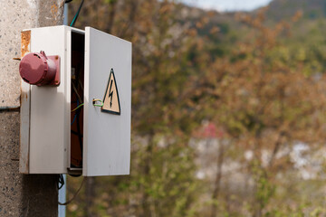 Electrical Control Box with Warning Sign in a Natural Setting
