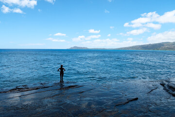 person standing by the ocean