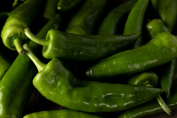 Fresh raw green peppers on table, genuine food ingredients, agricultural concept
