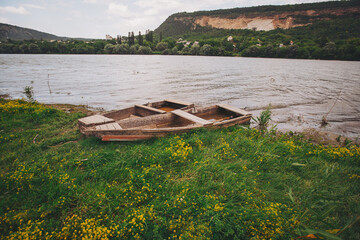 idyllic river scenery with boats. Rustic Fishing Boats .Old wooden dinghy on the shore
