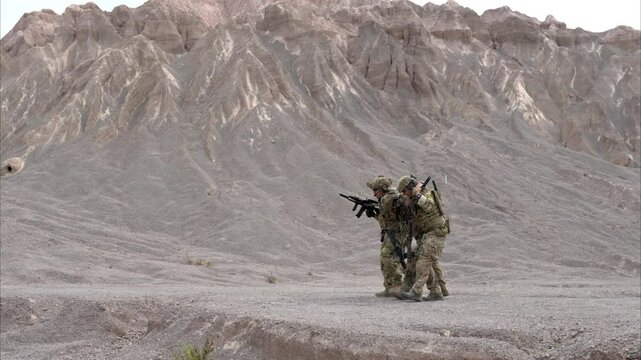 Soldiers in camouflage military uniforms carrying weapons, Reconnaissance missions in rugged mountains, Assault infantry battle training
