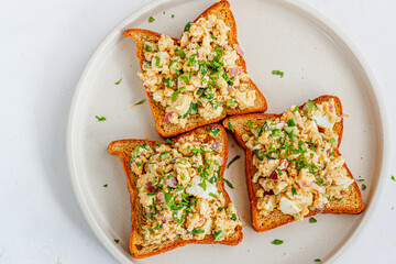 Open Faced Egg Sandwich Garnished with Fresh Basil and Peppers Directly Above Photo