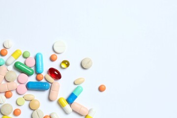 Various pills on white background