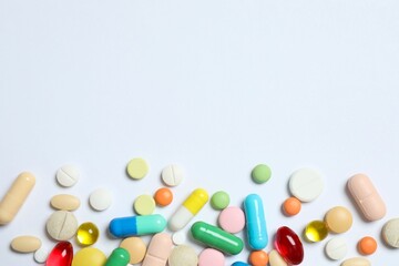 Various pills on white background