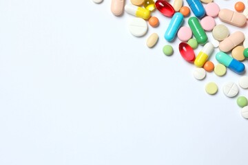 Various pills on white background