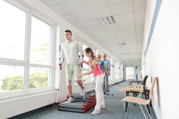 People in rehabilitation learning how to walk with crutches after having had an injury
