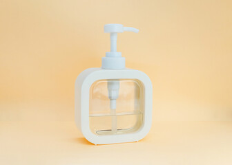 White modern soap or shower gel dispenser on light pastel background. Body hygiene
