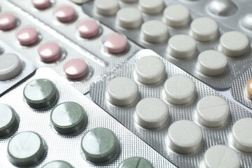 Various pills in blisters on white background