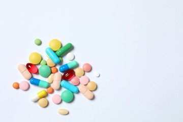 Various pills on white background