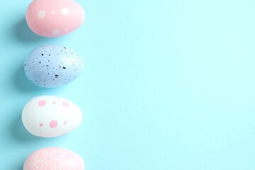 Happy Easter card. Easter eggs and decoration on color background, top view