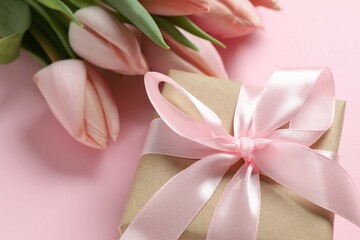 Fototapeta premium Beautiful fresh tulips with a gift box on color background