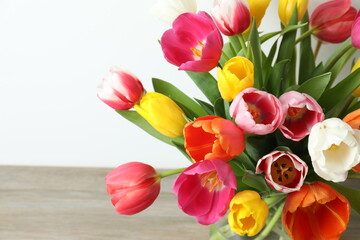 Beautiful fresh tulips on light background