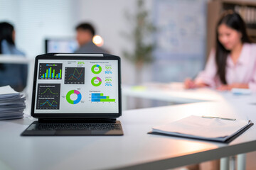 A laptop displaying a graph with a green bar on it