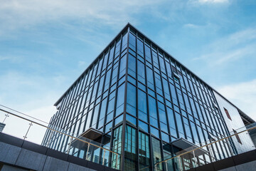 Modern Architectural Marvel with Glass Facade Against a Blue Sky