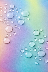 Big water droplets on multicolored rainbow background. Selective focus