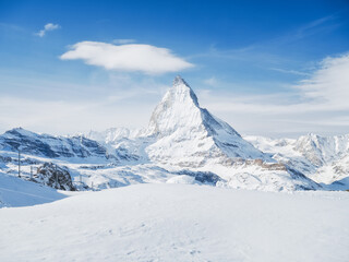 Matterhorn, Switzerland. Winter mountain landscape. A place for skiing. Zermatt ski resort. High rocks and snow. Mountain scene in Switzerland. Photo for postcards, backgrounds, wallpapers.