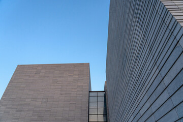 Contemporary Architectural Design with Geometric Shapes Against Clear Blue Sky