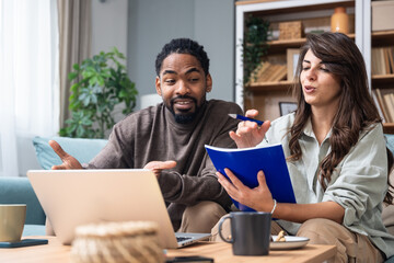 Two young people, couple in relationship, working together at home office. Start up new global business, casual businessman and businesswoman work finance and economy with laptop computer and document