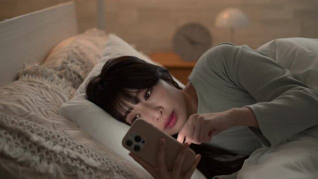 Animation tapping with close-up of a woman who looks at her phone in the middle of the night and falls asleep because she doesn't get enough sleep Neutral colors