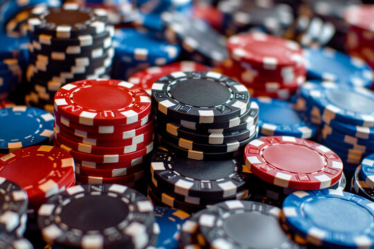 A close-up of colorful poker chips stacked together, symbolizing high-stakes gambling and competition. - Powered by Adobe