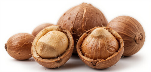 Brown nuts are arranged together, some partially opened to reveal their creamy insides. The lighting highlights the smooth surfaces and earthy tones of the shells