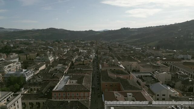 A stunning drone view of Teramo, Italy: rolling green hills, historic architecture, and vibrant cityscapes nestled in the Apennines. Breathtaking aerial perspectives!