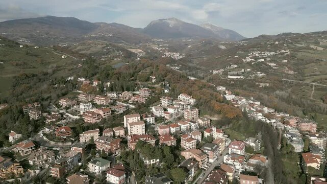 A stunning drone view of Teramo, Italy: rolling green hills, historic architecture, and vibrant cityscapes nestled in the Apennines. Breathtaking aerial perspectives!