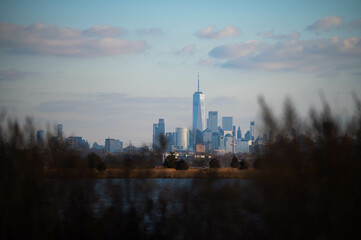 Manhattan skyscrapers skyline, cold winter day blue sky, travel destination background image, selective focus isolated subject, photo taken from New Jersey far away skyscrapers, background image